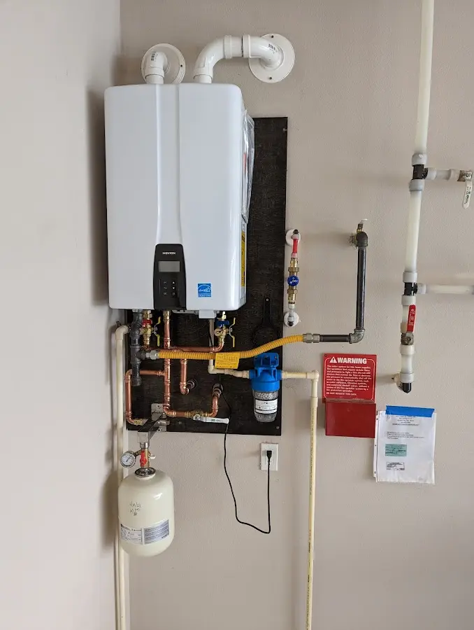 Professional plumber installing copper piping in a Jerome home